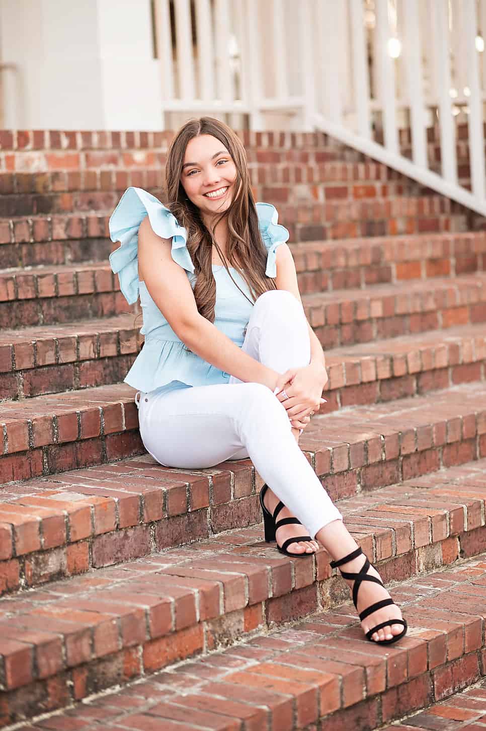 cute senior girl on steps in Stillwater
