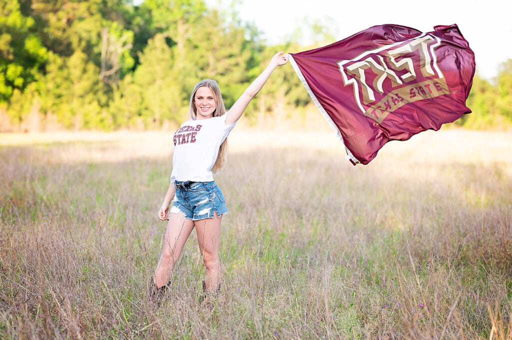 senior girl with a college flag in texas
